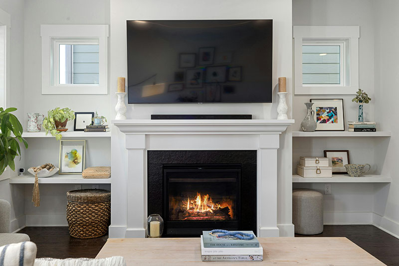 Living room with a lit fireplace